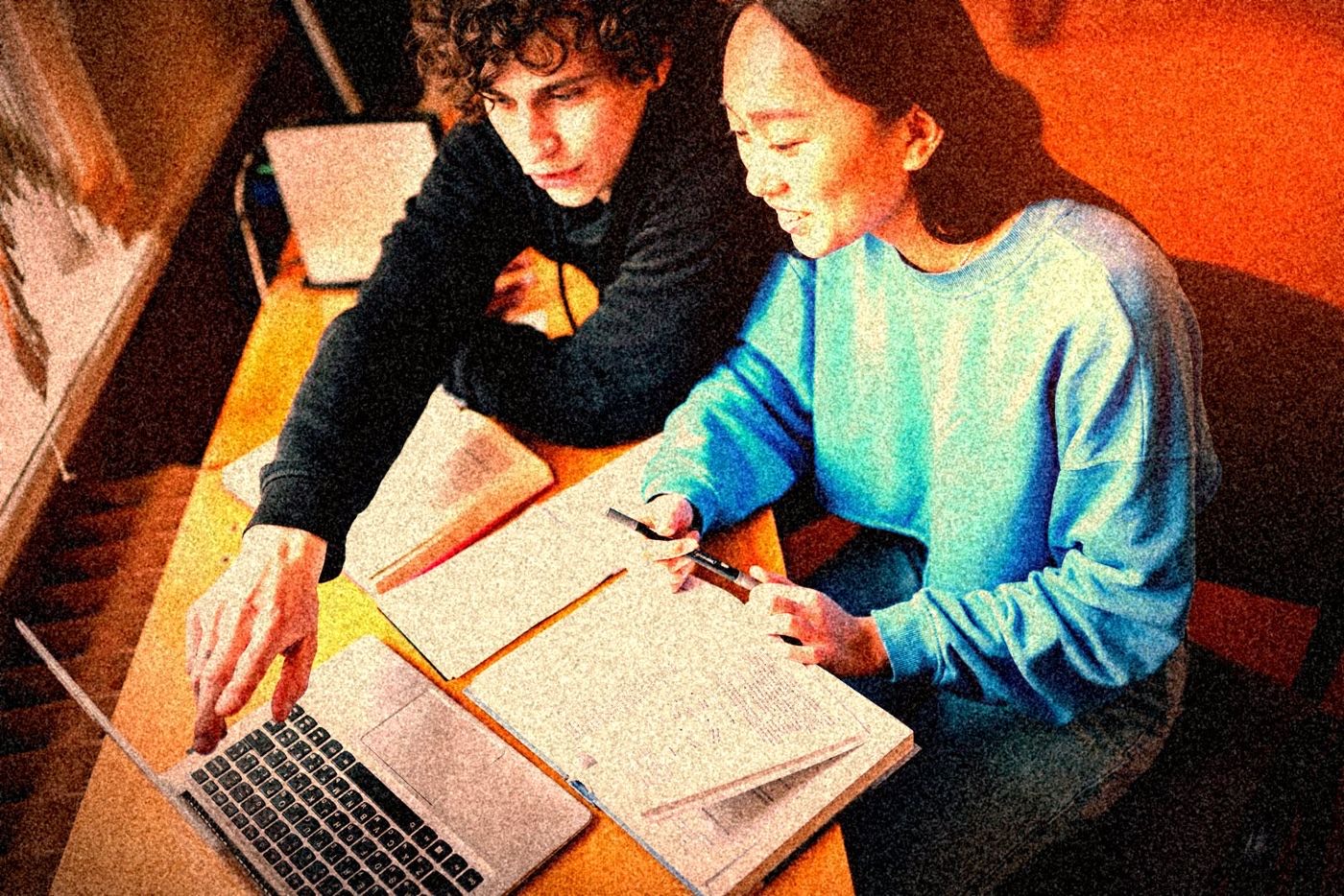 Deux étudiants francophones qui révisent ensemble, photographiés au flash.